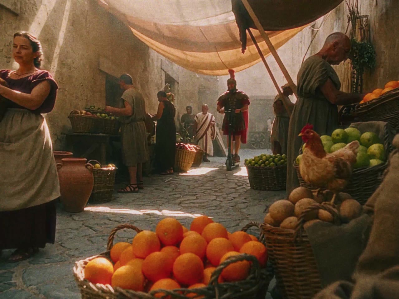 A legionary rides an electric scooter through a Roman market